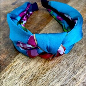 Floral headband with tie knot top.